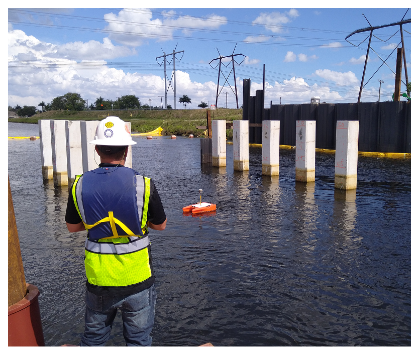 Worker observing water construction site with drone.